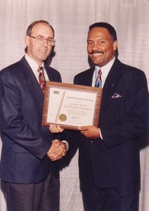 Dr. McElroy accepts Sections Board Award from SAE President Claude Verbal at the 1996 SAE International Congress and Exposition